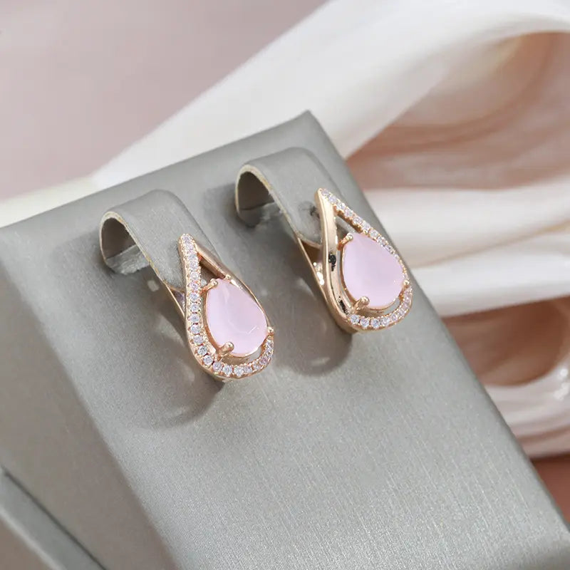 Elegant shiny earrings made of gold and pink cubic zirconia